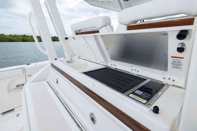 Slide: The Image of 2026 Pursuit S 328 Sport boat with onboard grill and seating area. - 10