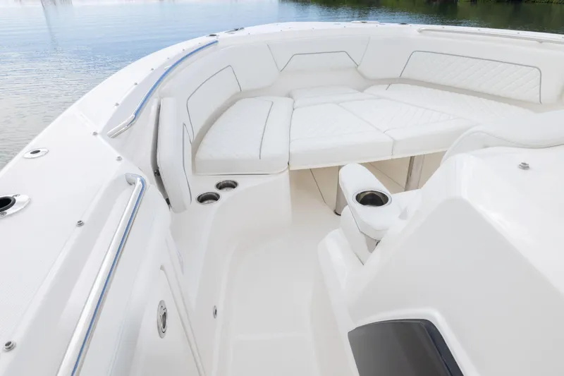 Slide: The Image of Luxurious seating area on 2026 Pursuit S 328 Sport boat, featuring white upholstery and cup holders. - 11