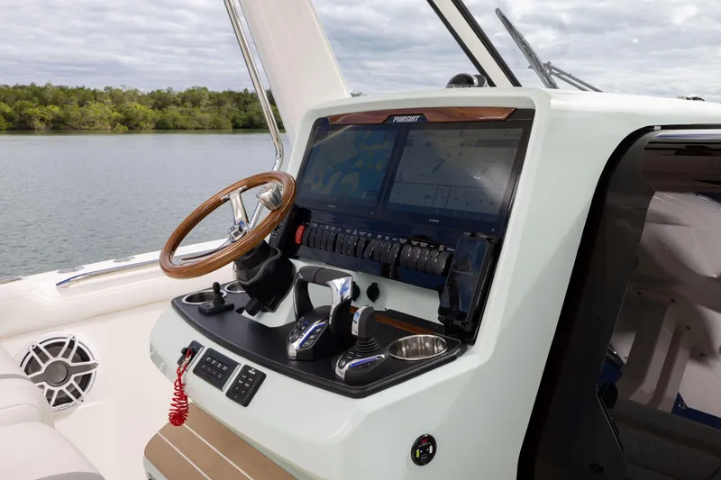 Slide: The Image of 2026 Pursuit S 328 Sport boat dashboard with advanced navigation system and controls. - 16