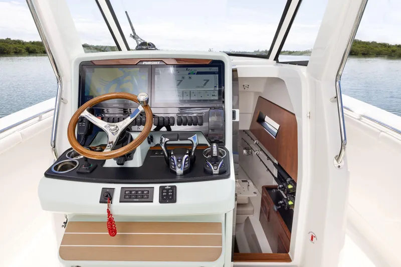 Slide: The Image of 2026 Pursuit S 328 Sport boat helm with advanced controls and cabin view. - 17