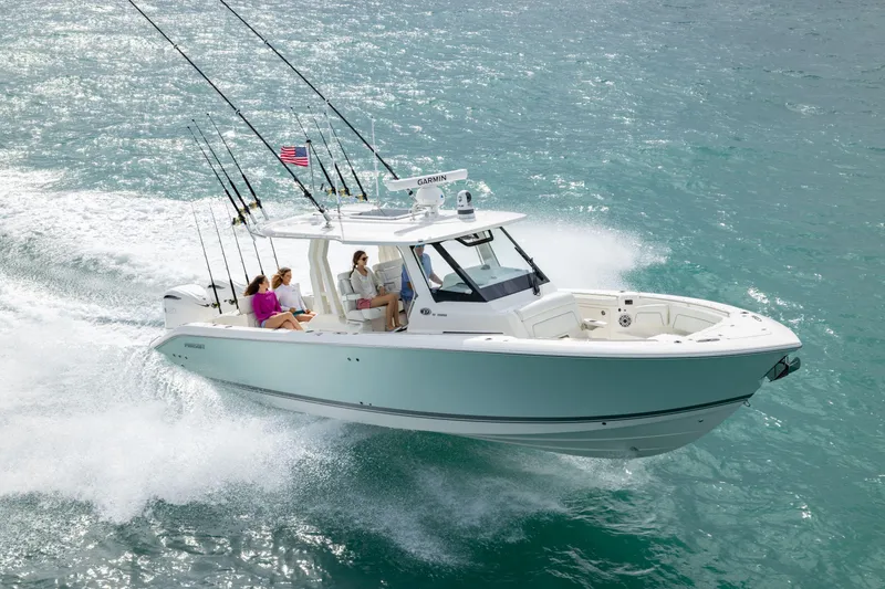 Slide: The Image of 2026 Pursuit S 328 Sport boat cruising on clear blue ocean waters. - 2