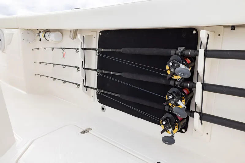 Slide: The Image of Fishing rod storage on 2026 Pursuit S 328 Sport boat, featuring secure holders and reels. - 20