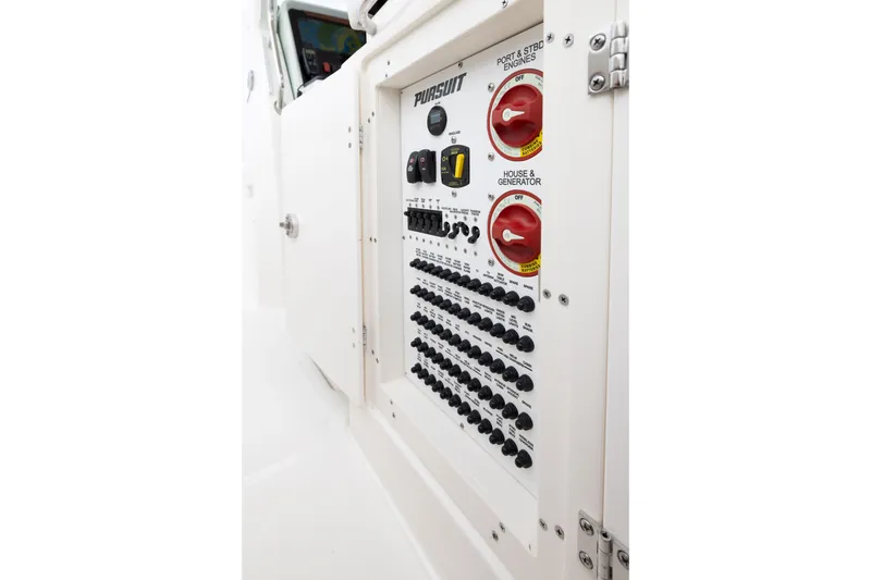 Slide: The Image of Electrical panel of 2026 Pursuit S 328 Sport boat, featuring switches and controls. - 21