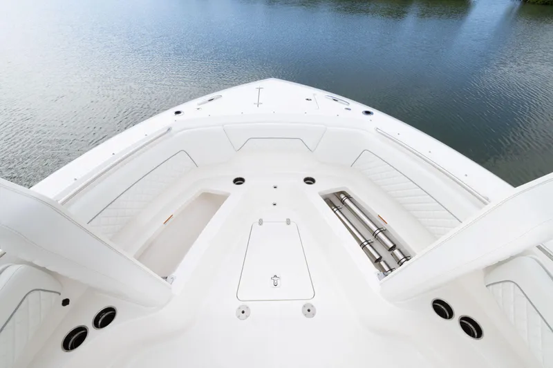 Slide: The Image of 2026 Pursuit S 328 Sport boat bow with sleek white seating and storage compartments. - 24
