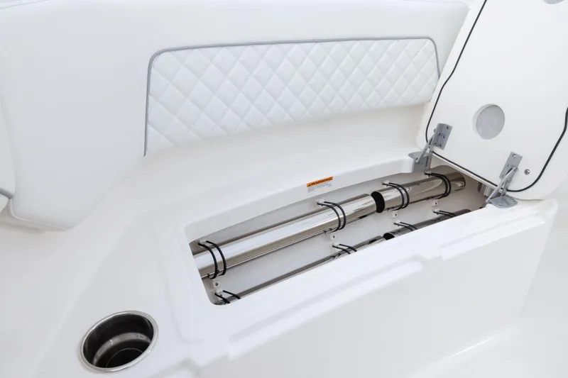 Slide: The Image of 2026 Pursuit S 328 Sport boat storage compartment with stainless steel rod holders. - 25