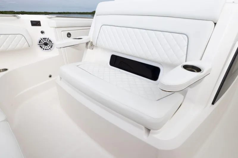 Slide: The Image of 2026 Pursuit S 328 Sport boat interior with white quilted seating and cup holders. - 27