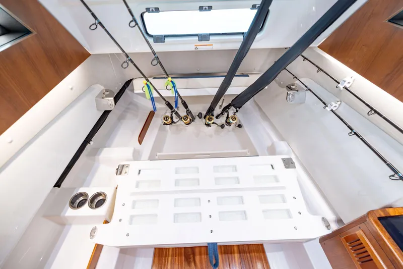 Slide: The Image of Interior of 2026 Pursuit S 328 Sport boat with fishing rod storage. - 30