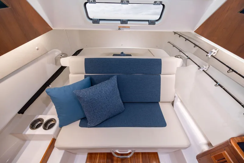 Slide: The Image of Interior of 2026 Pursuit S 328 Sport boat with blue and beige seating. - 32