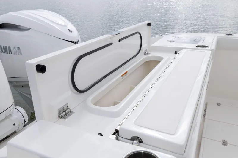 Slide: The Image of 2026 Pursuit S 328 Sport boat with open storage compartment and Yamaha engine. - 4