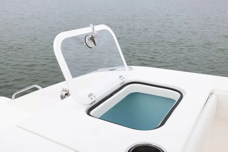 Slide: The Image of 2026 Pursuit S 328 Sport boat with open storage compartment on calm water. - 5
