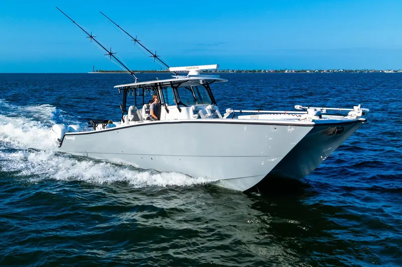 The Image of 2022 Freeman 42LR boat cruising on open water under clear blue skies. - 0