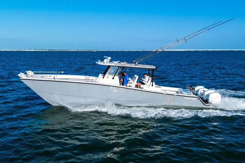 Slide: The Image of 2022 Freeman 42LR boat cruising on open water under clear blue skies. - 1