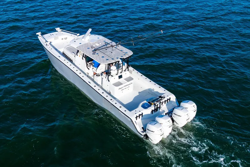 Slide: The Image of 2022 Freeman 42LR boat cruising on open water with four outboard engines. - 11