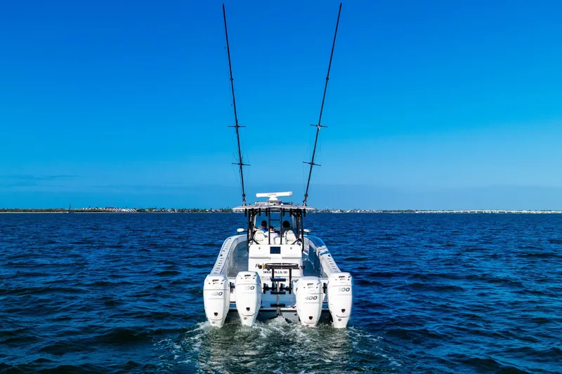 Slide: The Image of Freeman 42LR 2022 boat cruising on open water under clear blue sky. - 12