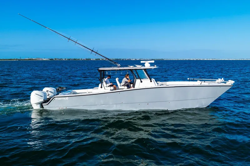 Slide: The Image of 2022 Freeman 42LR boat cruising on open water under clear blue skies. - 13