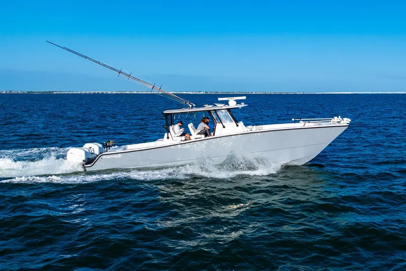 Slide: The Image of 2022 Freeman 42LR boat cruising on open water under clear blue skies. - 17
