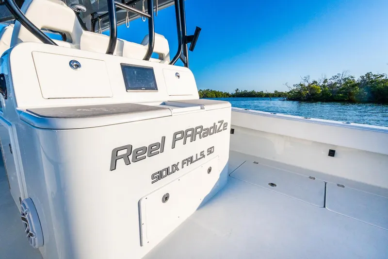 Slide: The Image of 2022 Freeman 42LR boat on water, featuring "Reel PARadiZe" text, clear blue sky. - 18
