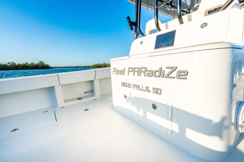Slide: The Image of Freeman 42LR boat named "Reel PARadiZe" on water, 2022 model, sunny day. - 19