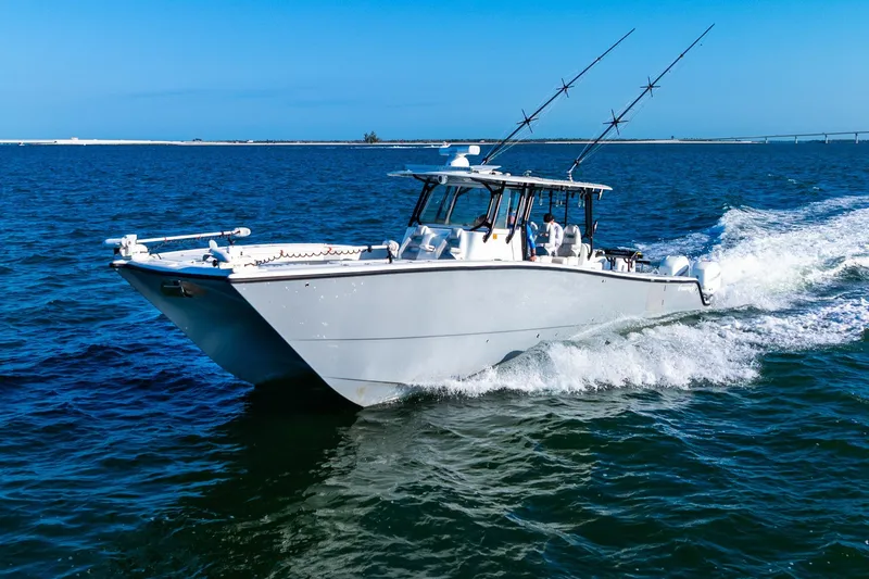 Slide: The Image of 2022 Freeman 42LR boat cruising on open water under clear blue skies. - 2