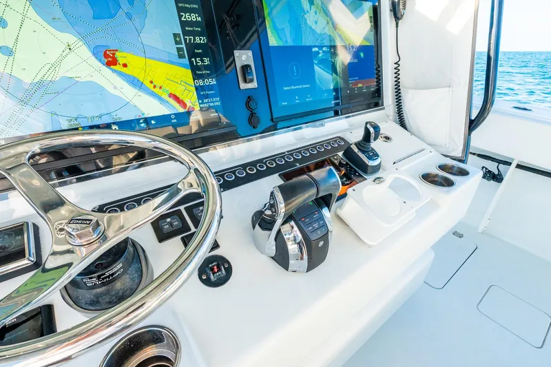 Slide: The Image of Control panel of a 2022 Freeman 42LR boat with navigation screens and steering wheel. - 30
