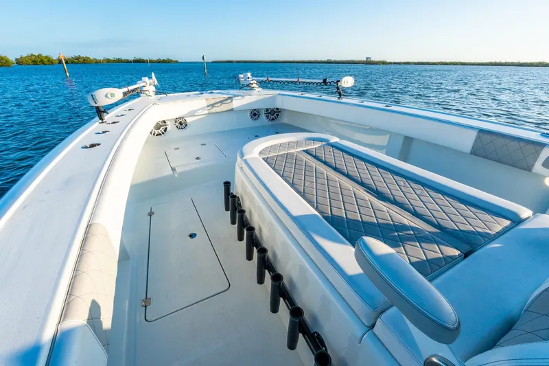 Slide: The Image of Luxurious 2022 Freeman 42LR boat interior with cushioned seating, rod holders, and ocean view. - 46