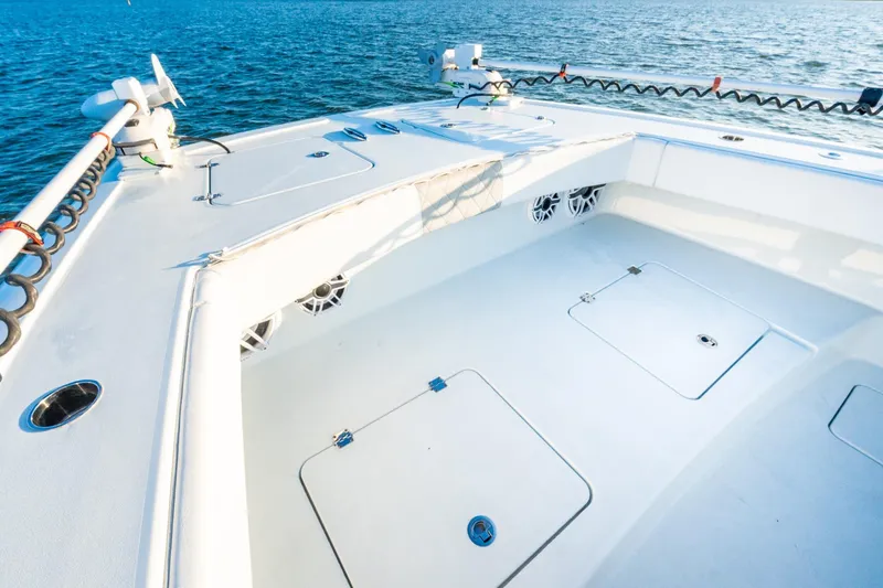 Slide: The Image of Freeman 42LR 2022 boat deck with storage compartments, on calm blue water. - 48