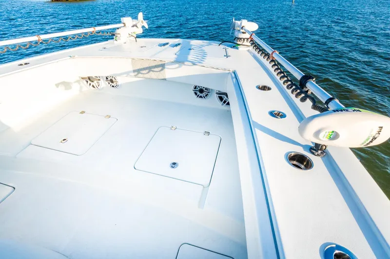 Slide: The Image of Freeman 42LR 2022 boat deck with storage hatches and fishing rod holders on the water. - 49