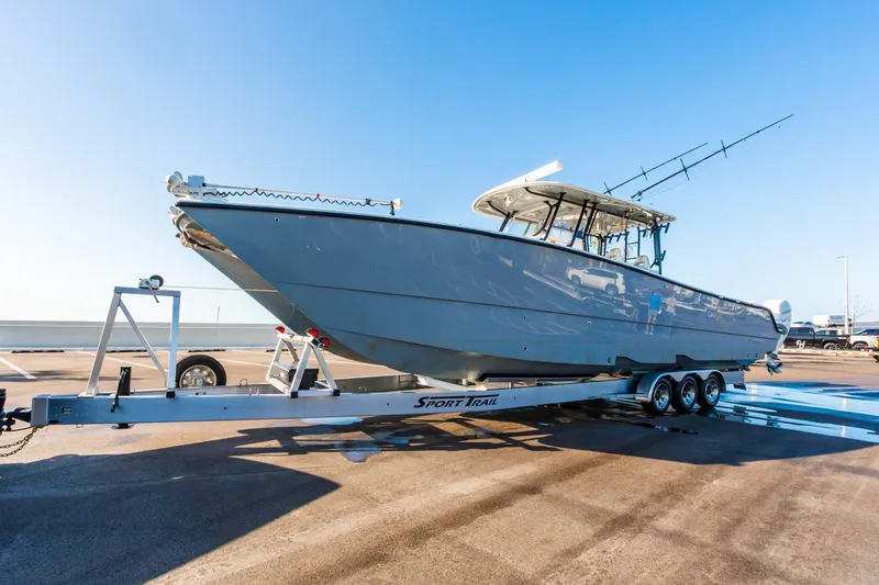 Slide: The Image of 2022 Freeman 42LR boat on trailer, parked outdoors under clear blue sky. - 66