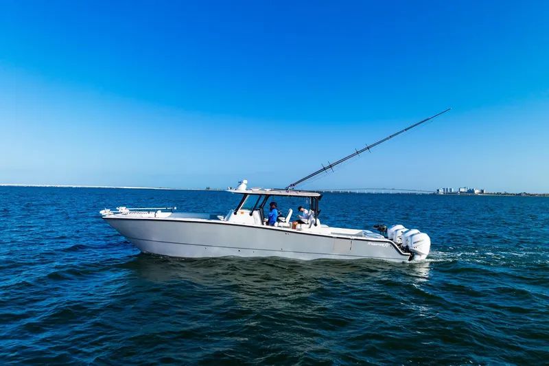 Slide: The Image of 2022 Freeman 42LR boat cruising on open water under clear blue sky. - 8