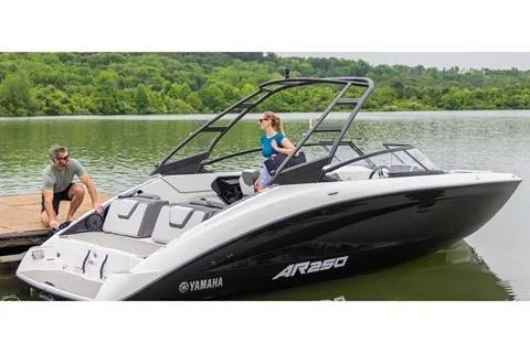 Slide: The Image of 2026 Yamaha Boats AR250 on a serene lake with lush green surroundings. - 14