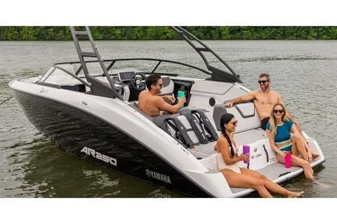 Slide: The Image of 2026 Yamaha Boats AR250 on a lake with people relaxing onboard. - 16