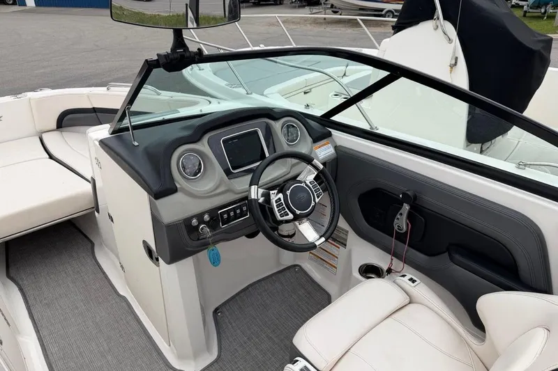 Slide: The Image of 2018 Chaparral Vortex 223 VRX boat interior with steering wheel and dashboard controls. - 7