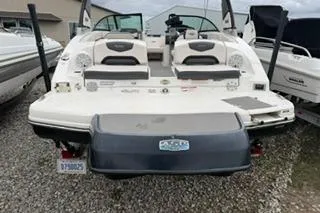 Slide: The Image of 2018 Chapparall Vortex 223 VRX boat, rear view, parked on gravel lot. - 3