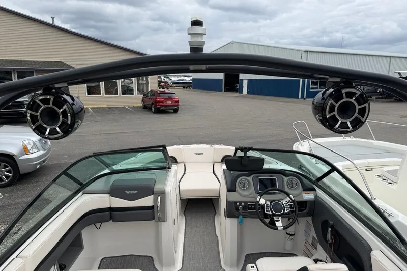 Slide: The Image of 2018 Chaparral Vortex 223 VRX boat interior with steering wheel and speakers. - 12
