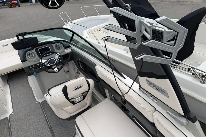 Slide: The Image of 2018 Chaparral Vortex 223 VRX boat interior with steering wheel and seating. - 14