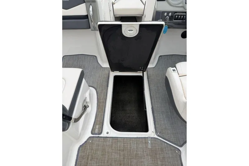 Slide: The Image of 2018 Chaparral Vortex 223 VRX boat interior with open storage compartment. - 18