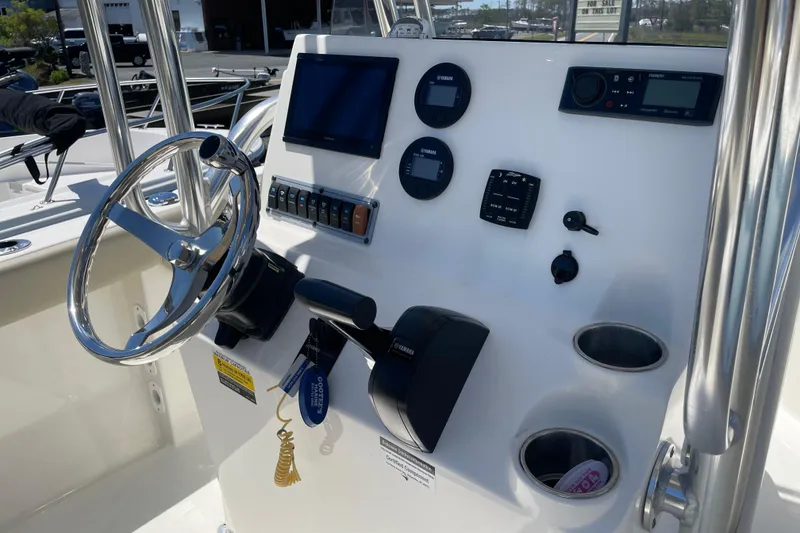 Slide: The Image of 2023 Key West 203 FS boat dashboard with steering wheel and control panel. - 10