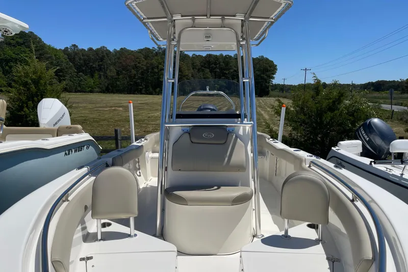 Slide: The Image of 2023 Key West 203 FS boat with seating and T-top, parked outdoors. - 6