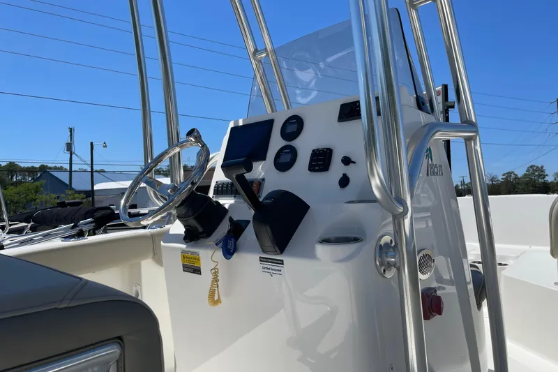 Slide: The Image of 2023 Key West 203 FS boat console with steering wheel and controls. - 7