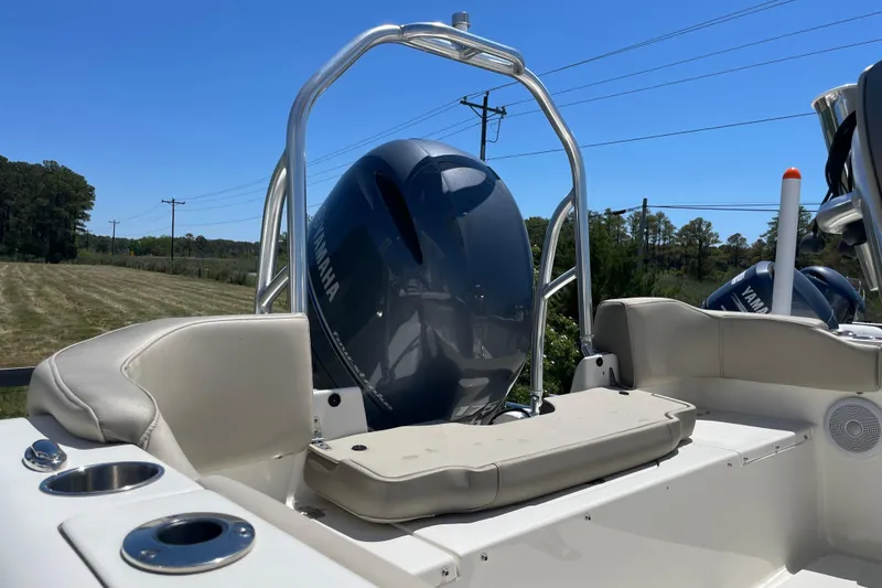 Slide: The Image of 2023 Key West 203 FS boat interior with Yamaha engine, featuring comfortable seating and cup holders. - 8