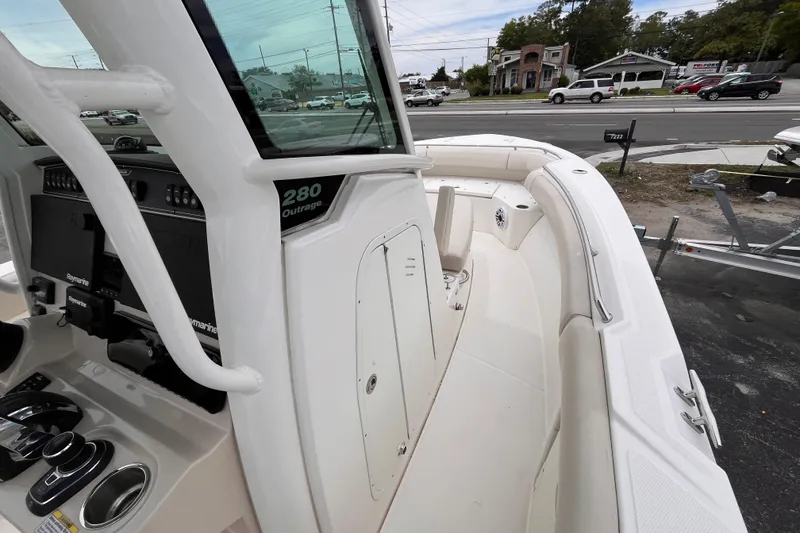 Slide: The Image of 2020 Boston Whaler 280 Outrage boat interior with helm and seating area. - 11