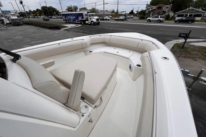 Slide: The Image of 2020 Boston Whaler 280 Outrage boat interior with cushioned seating and cup holders. - 13