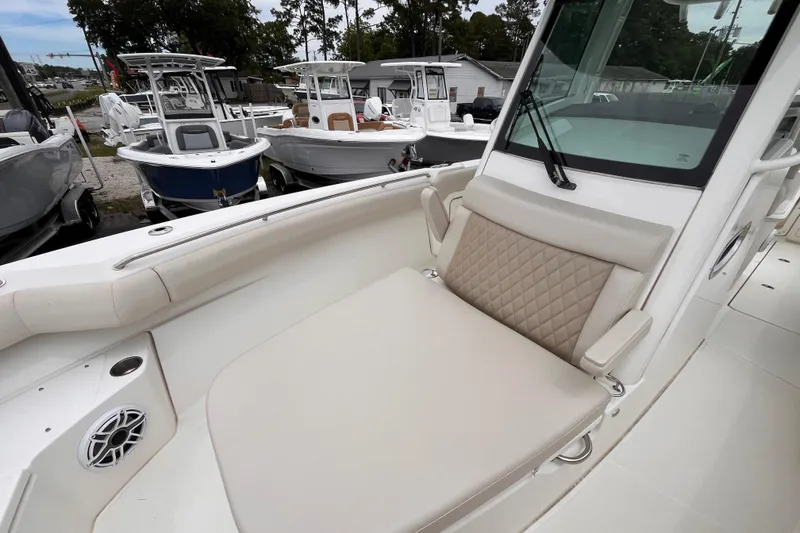 Slide: The Image of 2020 Boston Whaler 280 Outrage boat interior with cushioned seating and speaker system. - 14