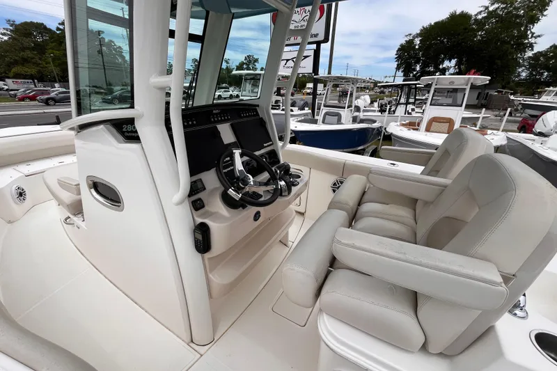 Slide: The Image of 2020 Boston Whaler 280 Outrage boat interior with steering console and seating. - 16