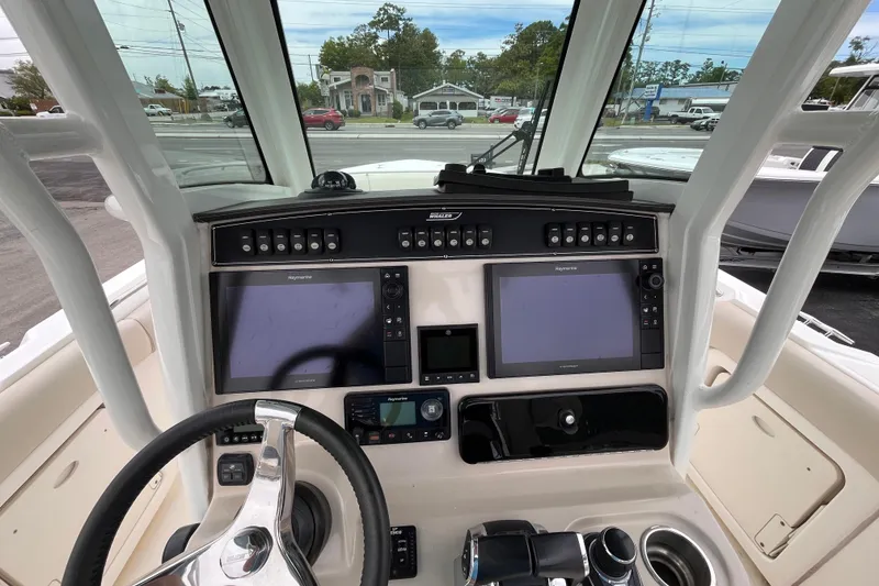 Slide: The Image of 2020 Boston Whaler 280 Outrage helm with dual Raymarine displays and steering wheel. - 19