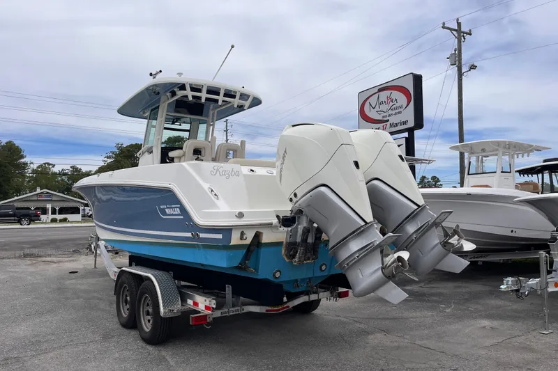Slide: The Image of 2020 Boston Whaler 280 Outrage boat on trailer, featuring dual outboard engines. - 2