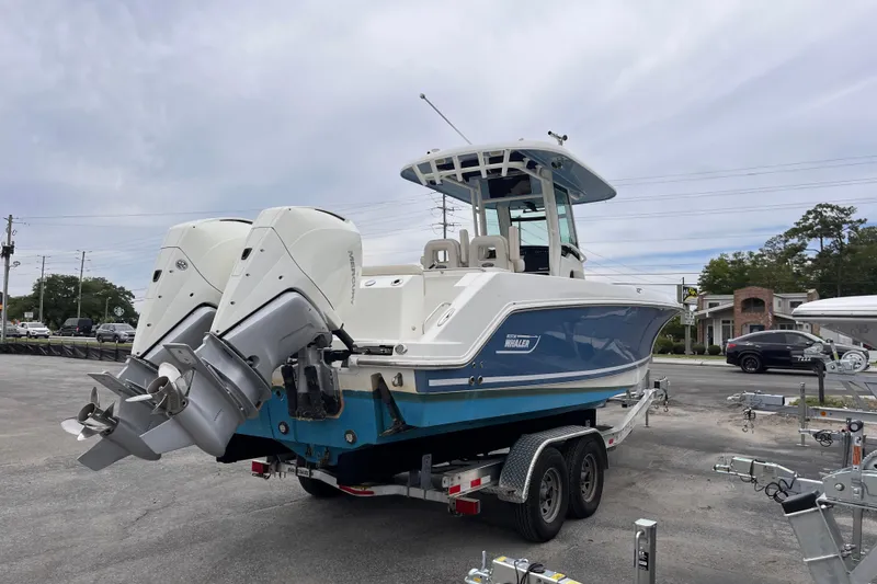 Slide: The Image of 2020 Boston Whaler 280 Outrage boat with dual engines on a trailer. - 4