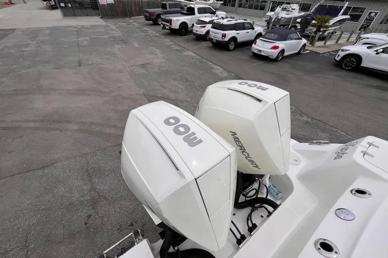 Slide: The Image of Twin Mercury 300 engines on a 2020 Boston Whaler 280 Outrage boat at a marina. - 5