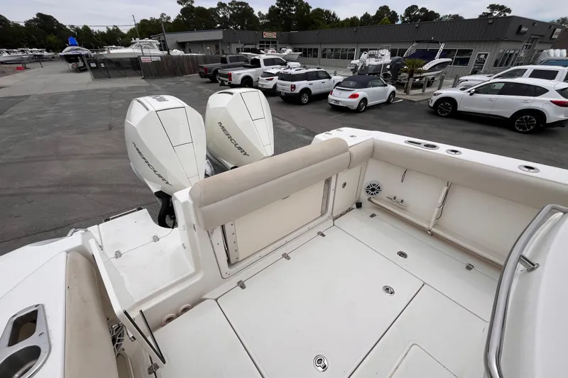 Slide: The Image of 2020 Boston Whaler 280 Outrage boat with dual Mercury engines at a marina. - 6