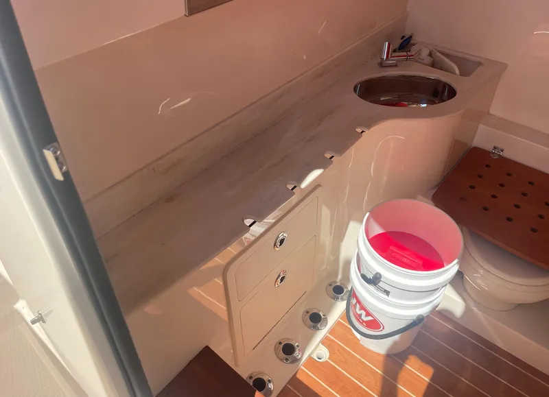 Slide: The Image of Interior of 2021 Grady-White Canyon 326 with sink and bucket. - 23